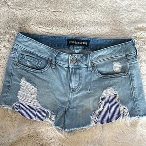 Express distressed jean shorts with striped pocket detail